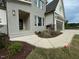 Stunning new home features light gray brick, dark garage door and professionally landscaped front yard at 5705 Flowery Meadow Ct, Wake Forest, NC 27587