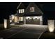 Charming home with brick accents, a modern garage door, and a patterned concrete driveway at night at 5705 Flowery Meadow Ct, Wake Forest, NC 27587
