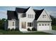 New construction with a brick and gray facade, and a two-car garage at 5705 Flowery Meadow Ct, Wake Forest, NC 27587