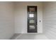 Modern front door with three glass panes and white trim siding at 5705 Flowery Meadow Ct, Wake Forest, NC 27587