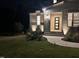 Beautiful front entrance features modern door, brick accents, stylish lighting and manicured lawn at 5705 Flowery Meadow Ct, Wake Forest, NC 27587