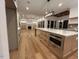 Spacious kitchen with stainless steel appliances, wooden cabinets, and an oversized island at 5705 Flowery Meadow Ct, Wake Forest, NC 27587