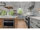 Modern kitchen with gray cabinets, stainless steel appliances, white countertops, and stylish tile backsplash at 5705 Flowery Meadow Ct, Wake Forest, NC 27587