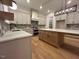 Bright kitchen with white cabinets, stainless appliances, hardwood floors, and a central island at 5705 Flowery Meadow Ct, Wake Forest, NC 27587