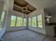 Bright living room featuring large windows, custom ceilings, and modern lighting fixtures at 5705 Flowery Meadow Ct, Wake Forest, NC 27587