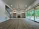 Spacious living room featuring a cozy fireplace and sliding glass doors to the outdoor deck at 5705 Flowery Meadow Ct, Wake Forest, NC 27587