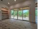 Open-concept living room with built-in shelving and large sliding doors leading to an outdoor patio at 5705 Flowery Meadow Ct, Wake Forest, NC 27587