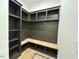 Well-organized mudroom with built-in shelving, hooks, and a bench for convenient storage at 5705 Flowery Meadow Ct, Wake Forest, NC 27587