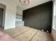 Office featuring dark accent wall with built in shelving, modern light fixture, and lots of natural light at 5705 Flowery Meadow Ct, Wake Forest, NC 27587