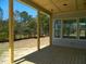 Covered patio area featuring a wooden deck with views of the wooded backyard, highlighting outdoor living at 5705 Flowery Meadow Ct, Wake Forest, NC 27587