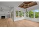 Sun room showcasing hardwood floors, a fireplace, built-in shelves and walls of windows for natural light at 5705 Flowery Meadow Ct, Wake Forest, NC 27587