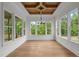 Sun room featuring hardwood floors, a decorative wood ceiling and large windows with beautiful backyard views at 5705 Flowery Meadow Ct, Wake Forest, NC 27587