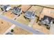 Aerial view showcasing a well-maintained street and large homes with landscaped yards at 58 Atkins Village Ct, Fuquay Varina, NC 27526