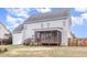 The backyard features a screened porch and plenty of open space at 58 Atkins Village Ct, Fuquay Varina, NC 27526