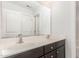 Bright bathroom features a double sink vanity with dark cabinets and a large mirror at 58 Atkins Village Ct, Fuquay Varina, NC 27526