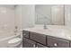 Well-lit bathroom features a tub/shower combination with a modern vanity and neutral color scheme at 58 Atkins Village Ct, Fuquay Varina, NC 27526