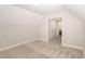 Bedroom with neutral carpet, light gray walls, and a doorway leading to another room at 58 Atkins Village Ct, Fuquay Varina, NC 27526