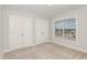 Bedroom with neutral carpet, light gray walls, two closets and a window with blinds at 58 Atkins Village Ct, Fuquay Varina, NC 27526