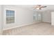 Bedroom featuring plush carpet, neutral color scheme, and large windows at 58 Atkins Village Ct, Fuquay Varina, NC 27526