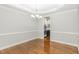 Traditional dining room featuring hardwood floors, crown molding, and a chandelier at 58 Atkins Village Ct, Fuquay Varina, NC 27526