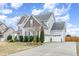 Lovely two-story home with a two-car garage, well-maintained lawn, and charming landscaping at 58 Atkins Village Ct, Fuquay Varina, NC 27526