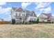 Beautiful two-story home with black shutters, a welcoming porch, and a lush green lawn at 58 Atkins Village Ct, Fuquay Varina, NC 27526