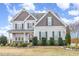 Charming two-story home with stone accents, dark shutters, manicured landscaping and covered entryway at 58 Atkins Village Ct Ct, Fuquay Varina, NC 27526