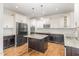 Kitchen featuring stainless appliances, a center island, and white cabinets at 58 Atkins Village Ct, Fuquay Varina, NC 27526