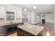 Kitchen with granite counters, stainless appliances, and opens to living room with fireplace at 58 Atkins Village Ct, Fuquay Varina, NC 27526