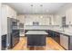Kitchen showcasing stainless steel appliances, a center island, and sleek white cabinets at 58 Atkins Village Ct, Fuquay Varina, NC 27526