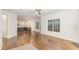 Spacious living area with hardwood floors, a ceiling fan, and an open view into a modern kitchen at 58 Atkins Village Ct, Fuquay Varina, NC 27526