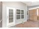 The screened porch has a ceiling fan and access to the outside, offering a blend of indoor/outdoor living at 58 Atkins Village Ct, Fuquay Varina, NC 27526