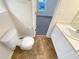 Cozy bathroom featuring a toilet, vanity with white countertop, and wood-look vinyl flooring at 5803 Osprey Cove Dr, Raleigh, NC 27604