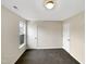A bedroom with carpeting, neutral walls, 2 white doors and a single window with a view to the outside at 5803 Osprey Cove Dr, Raleigh, NC 27604