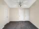 Spacious bedroom with neutral walls, plush gray carpeting, and white doors with a ceiling fan at 5803 Osprey Cove Dr, Raleigh, NC 27604