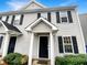 Charming two-story townhome with a welcoming front porch and black shutters at 5803 Osprey Cove Dr, Raleigh, NC 27604