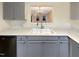 Kitchen showcasing gray cabinets, stainless steel dishwasher, sink, and white countertops with view to dining space at 5803 Osprey Cove Dr, Raleigh, NC 27604