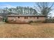 Backyard view of the brick home and the wooden patio at 628 Stratford Dr, Zebulon, NC 27597
