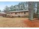 Spacious backyard featuring a brick home with wood patio and lawn at 628 Stratford Dr, Zebulon, NC 27597