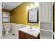 Bathroom features a framed mirror over a white sink with a modern vanity at 628 Stratford Dr, Zebulon, NC 27597