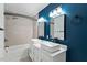 Modern bathroom with dual square vessel sinks, chrome fixtures, and tiled shower/tub combination at 628 Stratford Dr, Zebulon, NC 27597