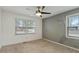 Bedroom with a ceiling fan, standard window, and gray accent wall at 628 Stratford Dr, Zebulon, NC 27597