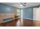Bright bedroom with wood floors, a ceiling fan, and a built in headboard and side tables at 628 Stratford Dr, Zebulon, NC 27597