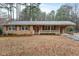 Charming brick home with a covered porch and a well-maintained front yard at 628 Stratford Dr, Zebulon, NC 27597