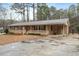 Inviting brick home featuring a cozy front porch and carport at 628 Stratford Dr, Zebulon, NC 27597