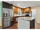 Well-lit kitchen features stainless appliances, wood cabinets, and a center island at 628 Stratford Dr, Zebulon, NC 27597