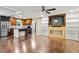 Open-concept living room and kitchen with hardwood floors and stainless steel appliances at 628 Stratford Dr, Zebulon, NC 27597