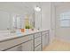Bright bathroom with double vanity and a large mirror at 6509 Archwood Ave, Raleigh, NC 27616