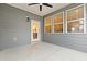 This is a view of the covered patio with a ceiling fan, lighting, and a white door that goes into the house at 6509 Archwood Ave, Raleigh, NC 27616