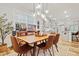 Open-concept dining room featuring a modern light fixture and access to the kitchen at 6509 Archwood Ave, Raleigh, NC 27616